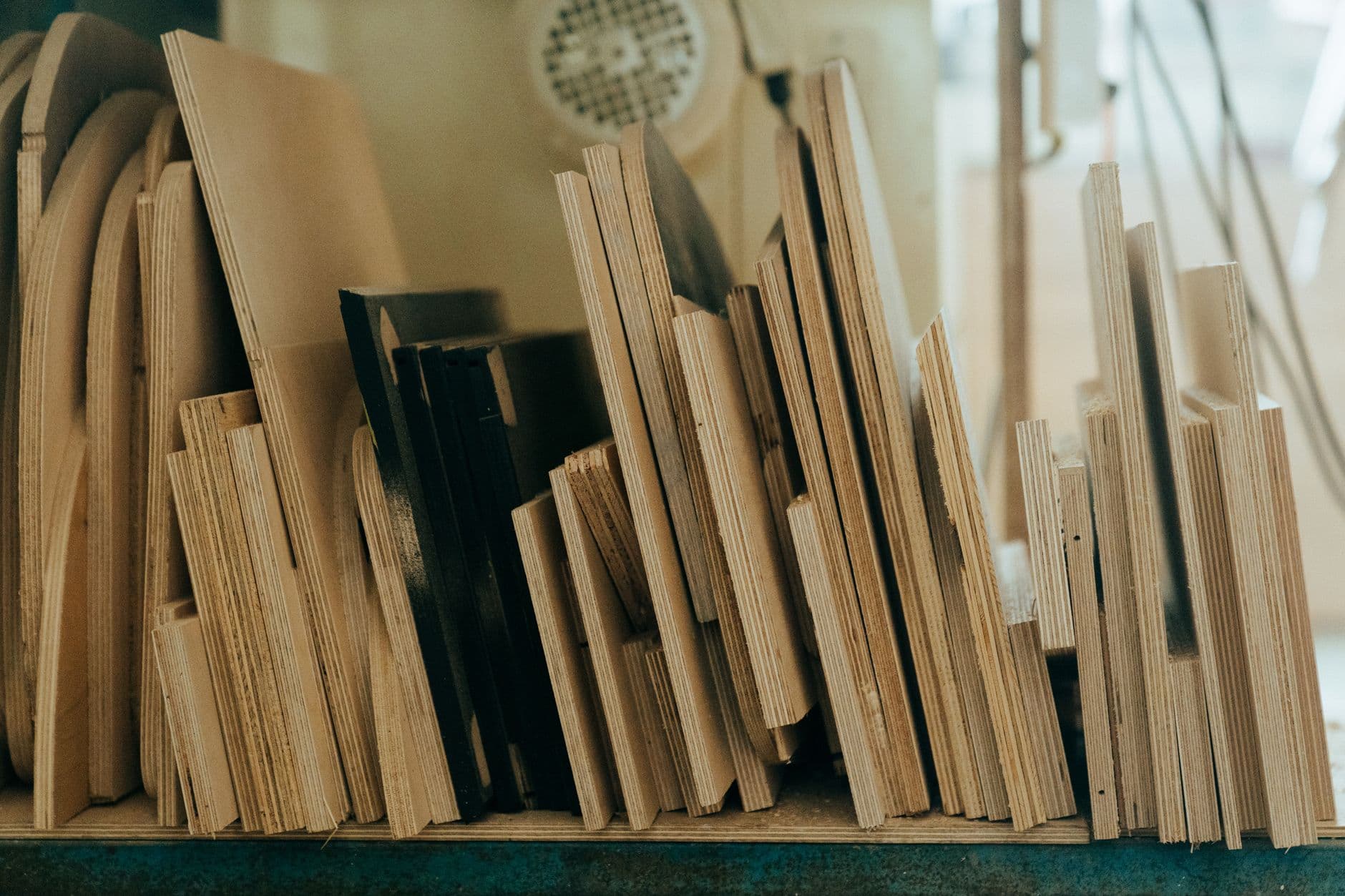 Flat laser-cut plywood box panels laid out on a table