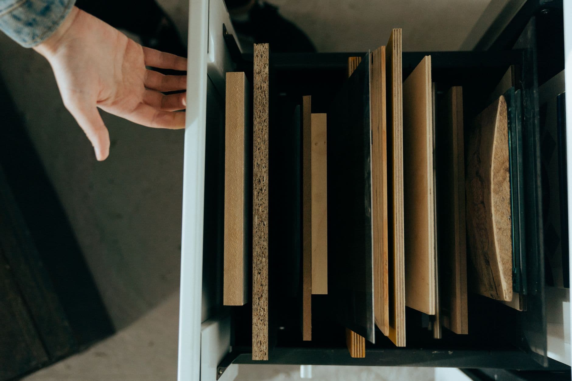 Laser-cut plywood organizer trays in a workshop drawer