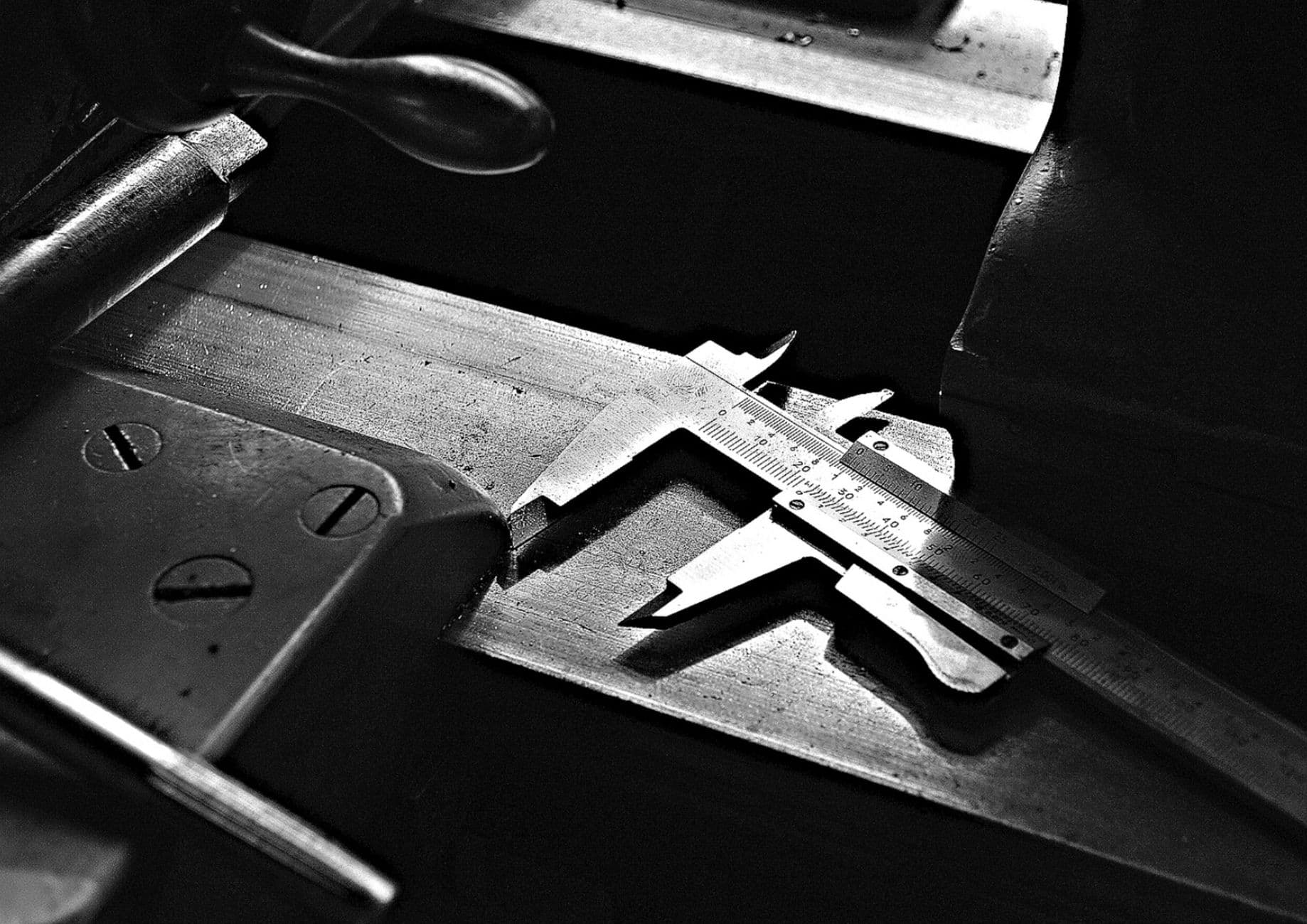 Machinist hand tools laid out on a workbench